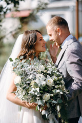 The first meeting of the bride and groom on their wedding day in the garden. Waiting and emotions of the newlyweds. The first kiss of the bride and groom