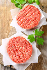 Raw minced meat for home made grill burgers cooking with spaces and herbs.