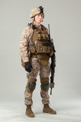 Soldier in camouflage holding rifle