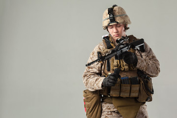 Soldier in camouflage holding rifle