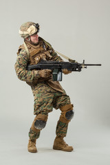 Soldier in camouflage holding rifle