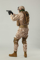 Soldier in camouflage holding rifle