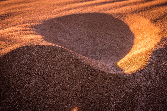 Light and shadows on  sand on the beach in Greece