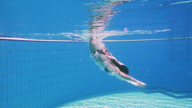 Young girl dive in swimming pool