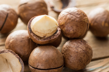 Macadamia nuts or bush nuts on the wooden table.