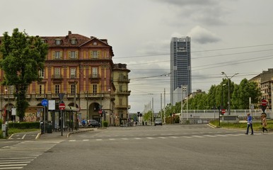 Turin, Italy, Piedmont. May 1 2018. In the background the skyscraper, headquarters, of the Intesa-SanPaolo bank. Photos taken from piazza Statuto, cars drive through the square and pedestrians cross.