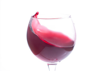 A glass with red wine on a white background. Isolate