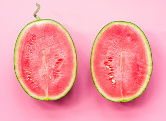 creative layout of fruit. a watermelon halves on pink background