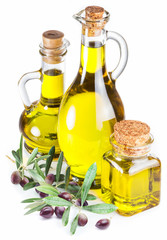 Bottles of olive oil and olive berries on white background.