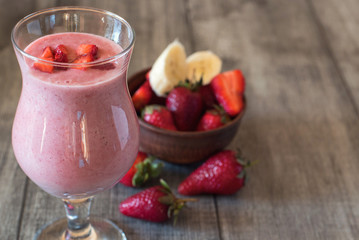 Strawberry milkshake with berries in the glass