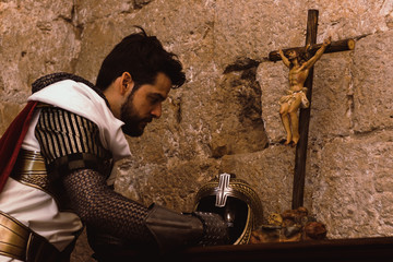 Medieval Templar soldier praying