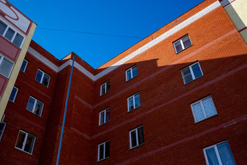 Facade of an apartment building against the blue sky