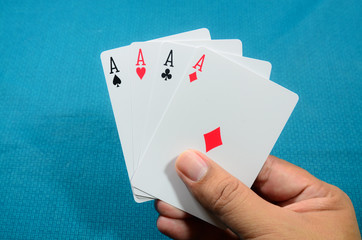Hand and four aces , playing cards