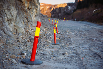 Road warning pillars, standing along the curb.