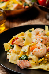 Traditional Italian fettuccini with salmon, shrimp and spinach.
