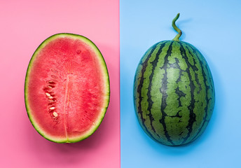 creative layout of fruit. a watermelon halves on pink and blue background