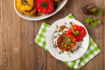 Colorful baked with cheese, stuffed peppers with rice and minced meat.