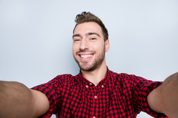 Close up portrait of cheerful excited carefree restless active positive amusing guy with toothy beaming smile having a video chat via internet on holidays, isolated on gray background