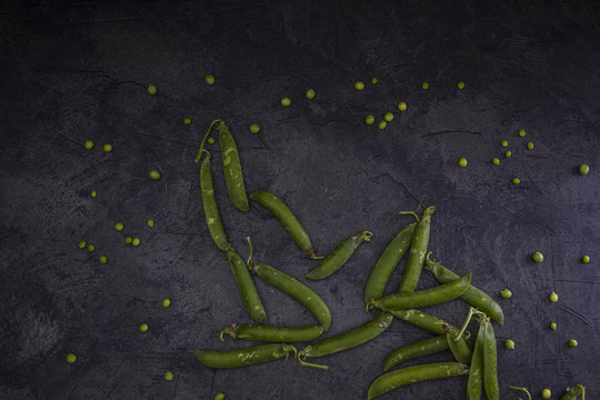 Green peas on dark background