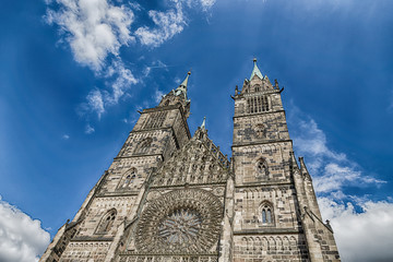 Fototapeta premium Saint Lawrence cathedral on the blue sky background. Medieval gothic church in Nuremberg, Germany