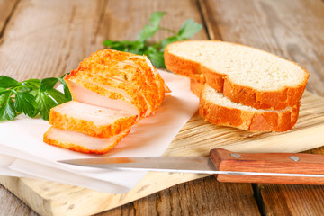 Pork lard with greens on a wooden table.