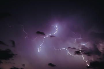 Dark sky lit up by lightning during thunderstorm in Warsaw, Poland