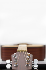 An acoustic guitar headstock on white background.