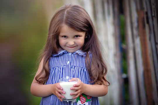 Cute little beautiful girl with milk