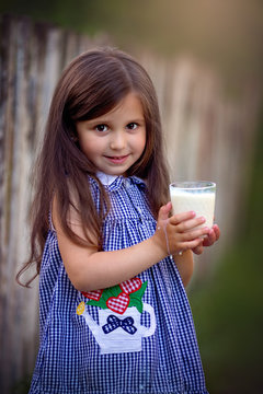 Cute little beautiful girl with milk