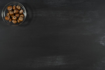 Hazelnuts in a bowl on the chalkboard.