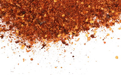 Crushed red cayenne pepper, dried chili flakes and seeds pile isolated on white background, top view