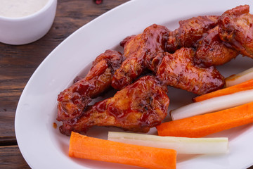 Chicken wings in tomato sauce with vegetables