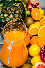 Fresh squeezed juice with fruits, cold drink with orange and other tropical fruits