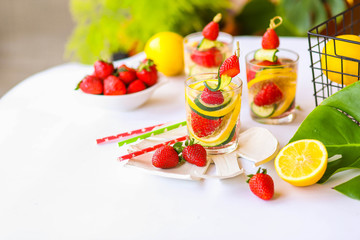 Traditional Pimms cocktail with lemonade, strawberries, cucumber, orange and mint