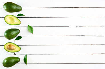 Fresh avocado on white wooden background