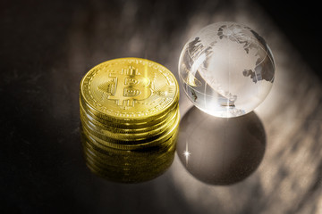 Glass globe and Bitcoin Cryptocurrency. Business concept