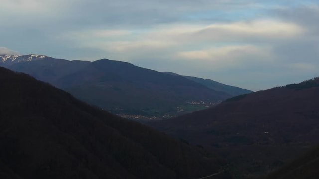 Time-lapse of darkening sky over the valley in Italy