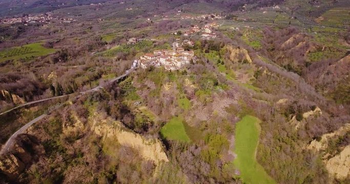 Aerial, Le Balze del Valdarno, giant ancient hills made of sand, clay, argil and gravel situated in Tuscany in Italy and a little town Piantravigne close to them