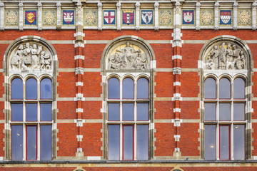 Architectural fragments of Historic building of Amsterdam central railway station (Amsterdam Centraal), Netherlands. Amsterdam Centraal's building first opened in 1889.