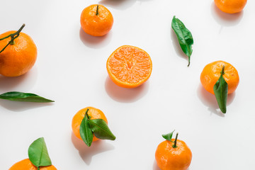 Background of fresh citrus with leaves on white. Flat lay. Top view