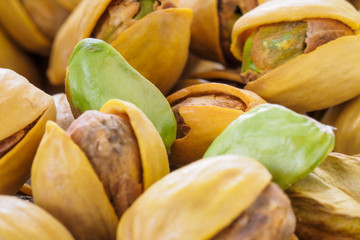 Close-up of pistachio. Selective focus on foreground.Pistachios texture. Nuts. Roasted salted pistachio nuts healthy delicious food studio photo.