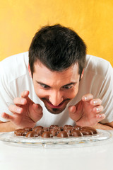 young man looking at the chocolates