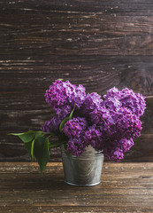 Lilac flowers in decorative tin bucket