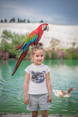 parrot on the little girl © Emre