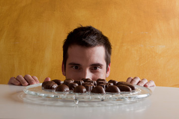 young man looking at the chocolates