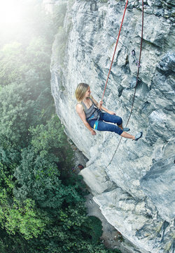 woman rock climber climbed on the cliff