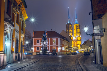 Christmas cityscape - evening view of the Monument Saint John of Nepomuk and the Cathedral of St. John the Baptist, located in the Ostrow Tumski old district of the city of Wroclaw, Poland