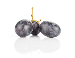 Black grape three berries (autumn royal variety) isolated on white background.