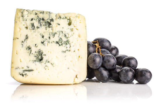 Black grape cluster (autumn royal variety) with a blue mold cheese isolated on white background.