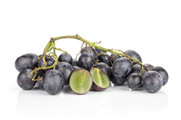 Black grape cluster (autumn royal variety) isolated on white background one purple berry cut in two halves.